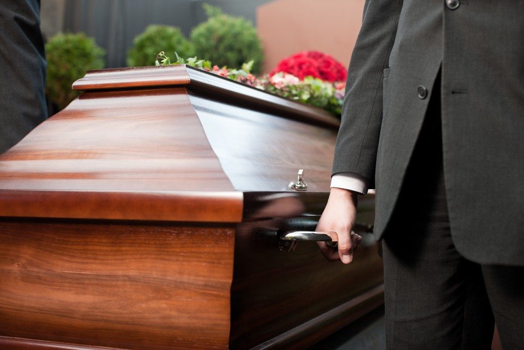 Men carrying a wooden casket