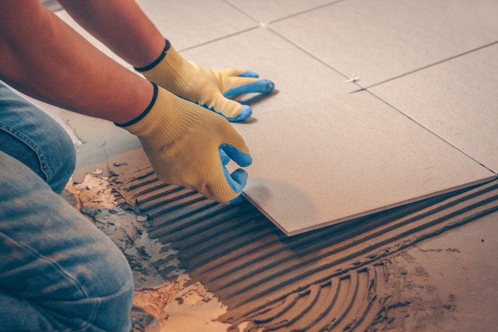 Man placing tiles