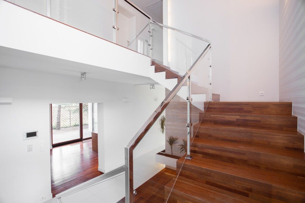 solid wooden stairs with elegant glass balustrade