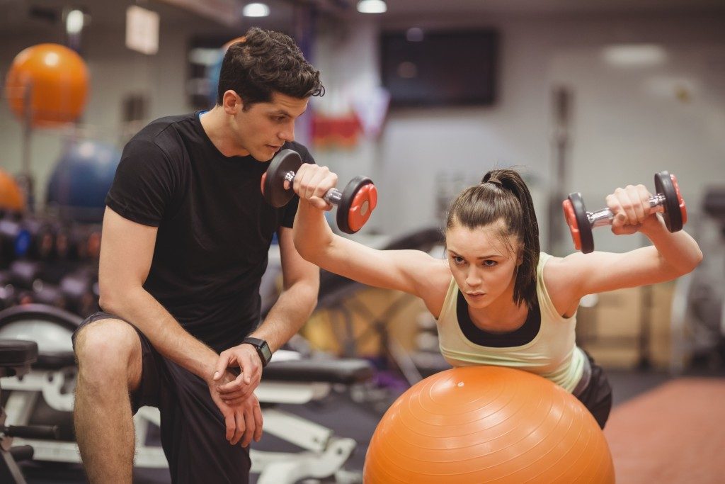 Woman working out with a coach