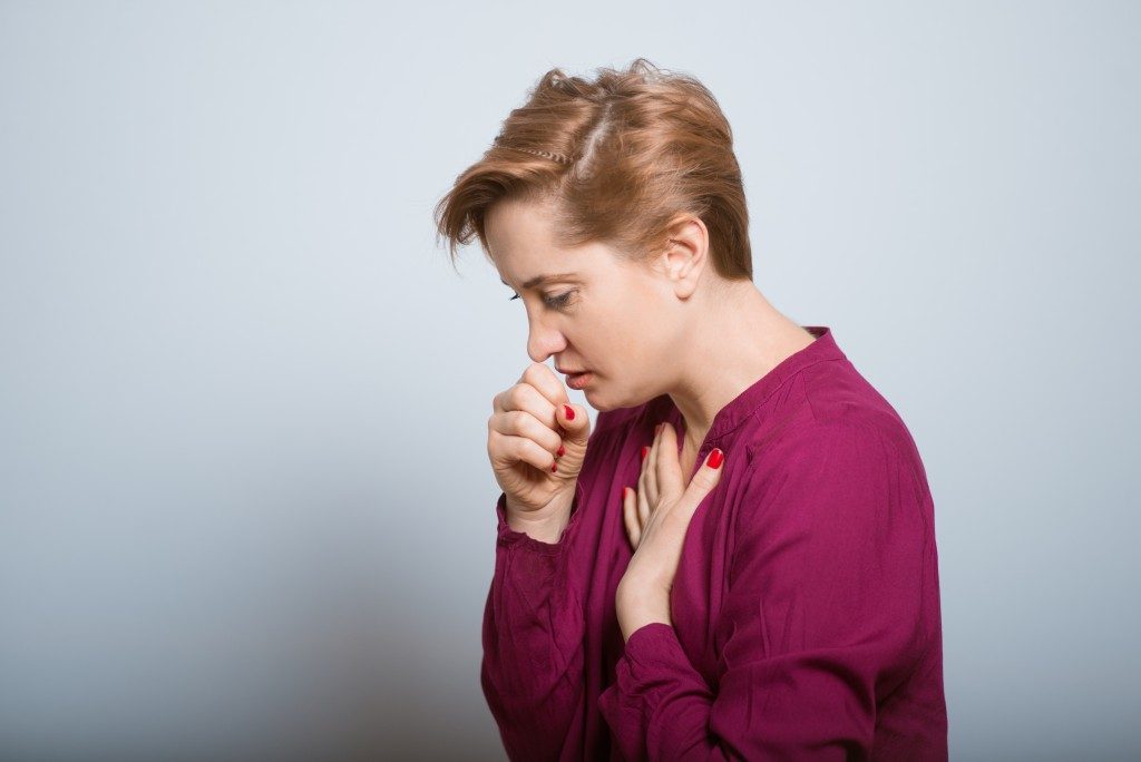 woman having a hard time coughing