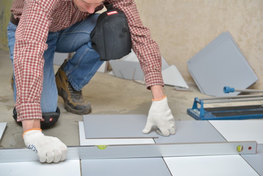 contractor installing tiles