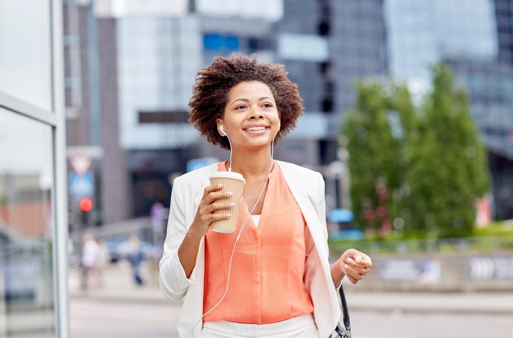 woman on her way to work while having a coffee