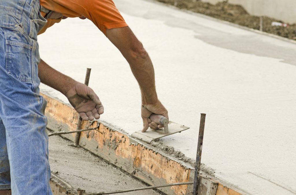 man laying cement