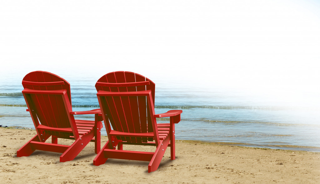 two red chairs by the beach