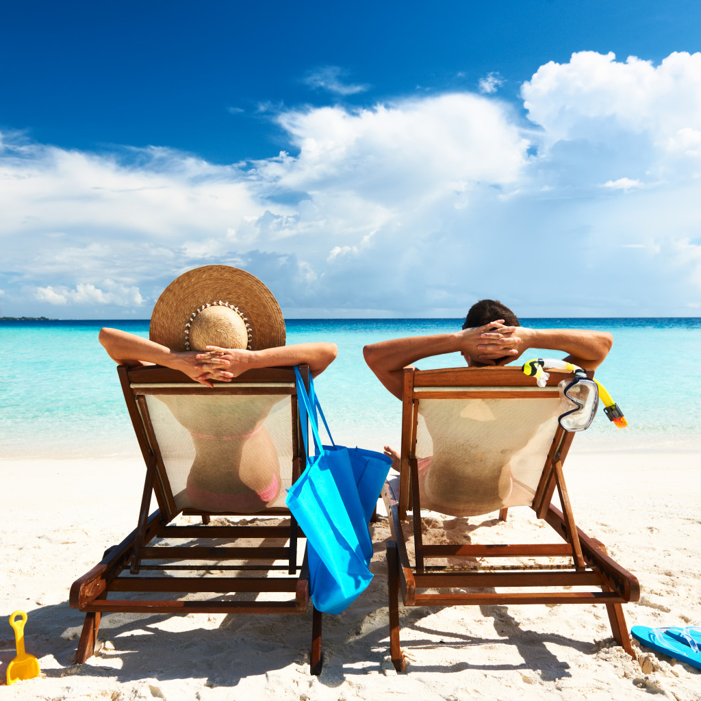 two people sitting by the beach