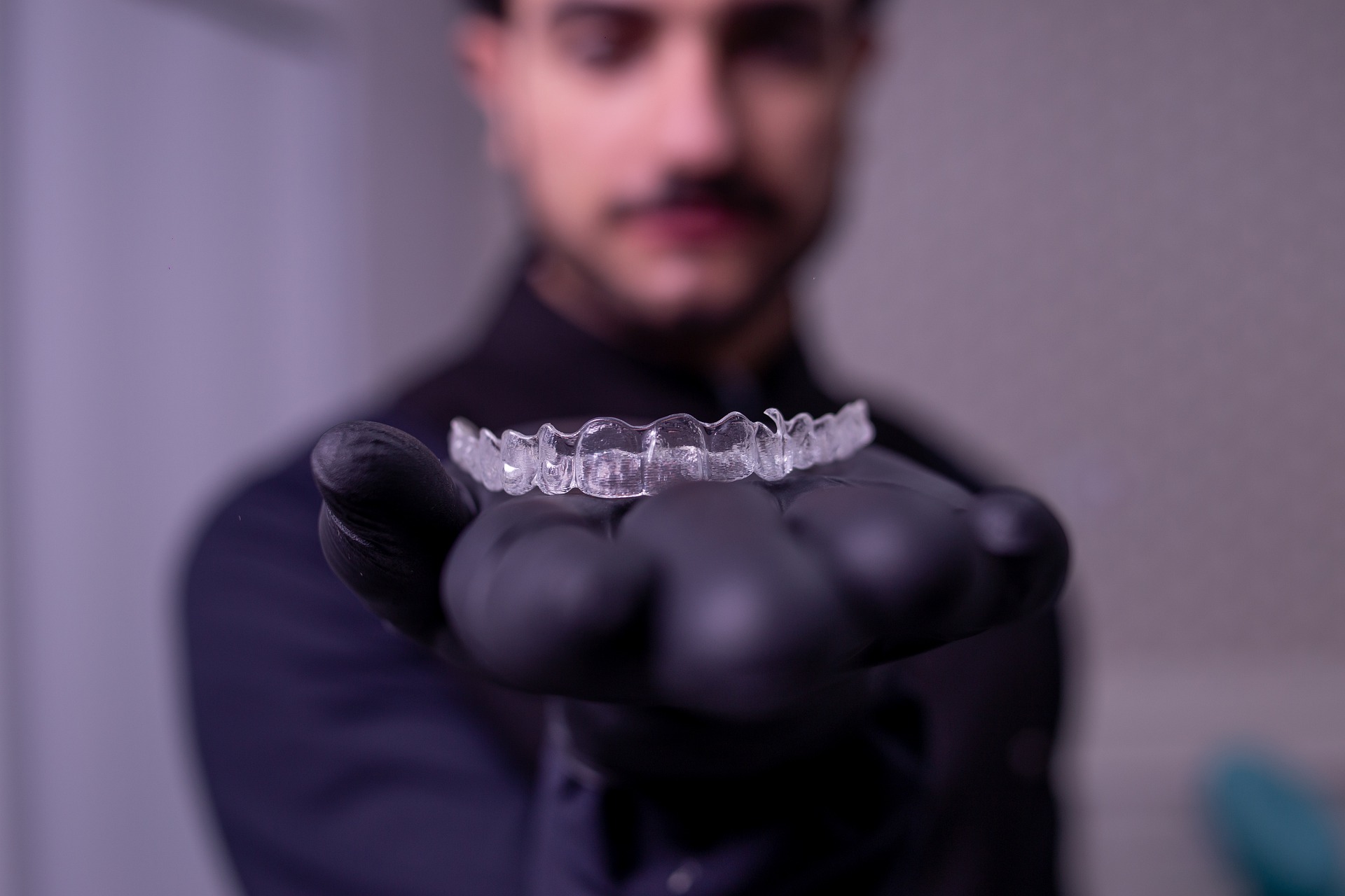 dentist holding invisalign