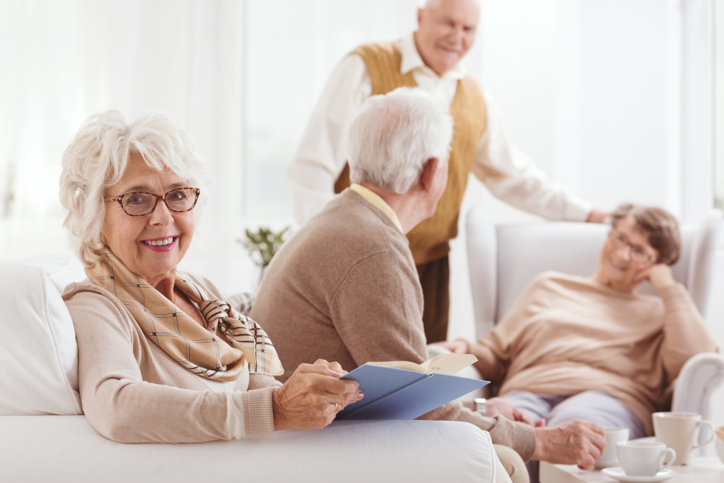 a portait of a senior woman with other senior peers at the background