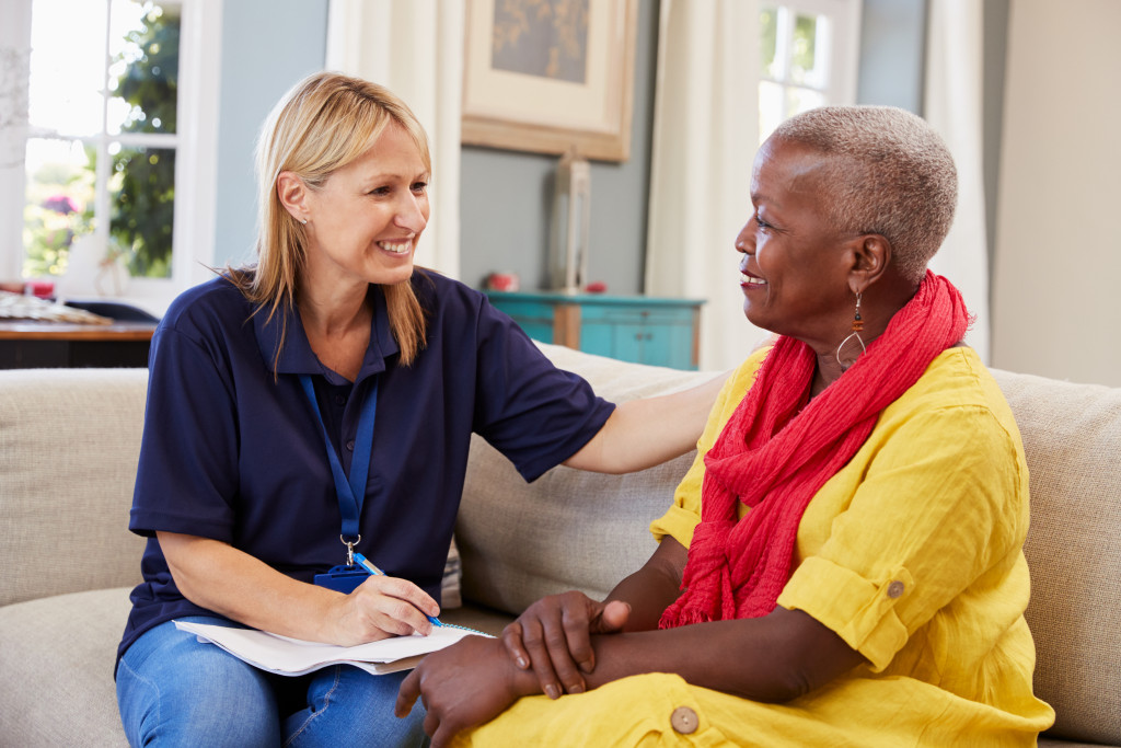 Care worker visiting senior woman at home