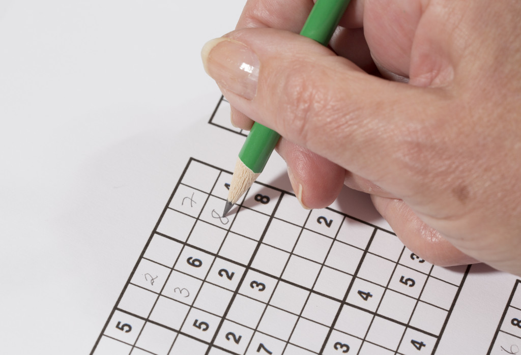 A person solving sudoku puzzle