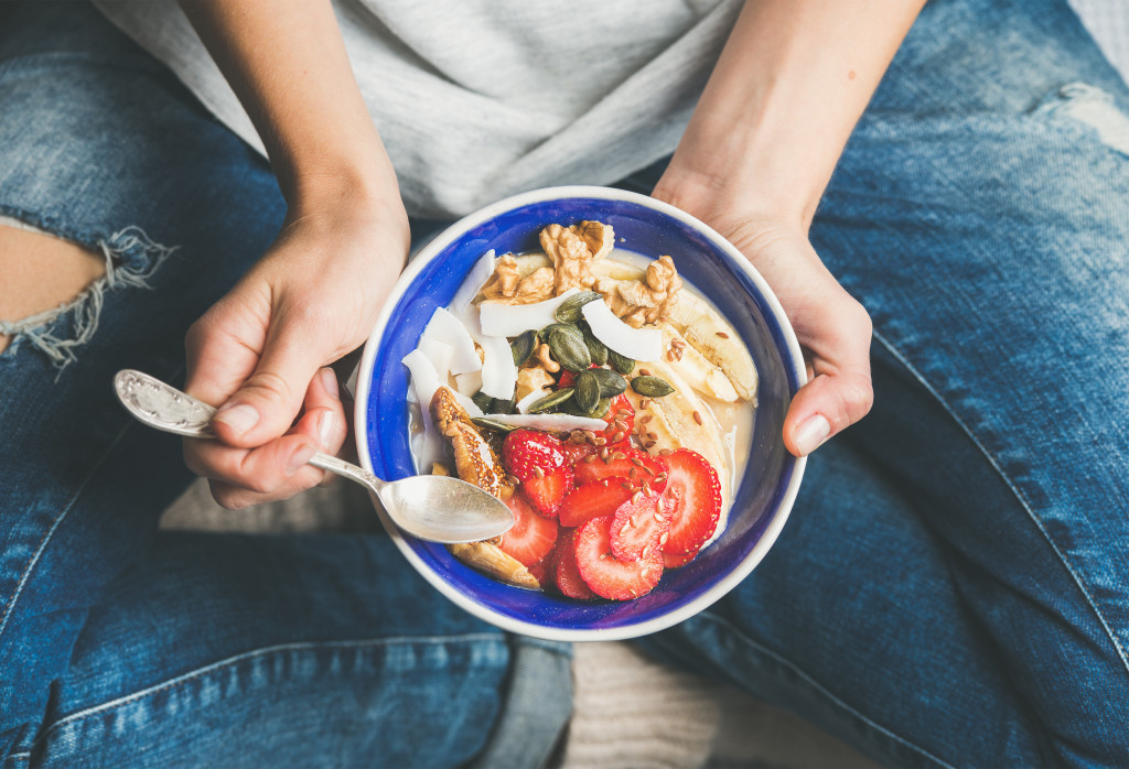 man eating a bowl of cereal sitting