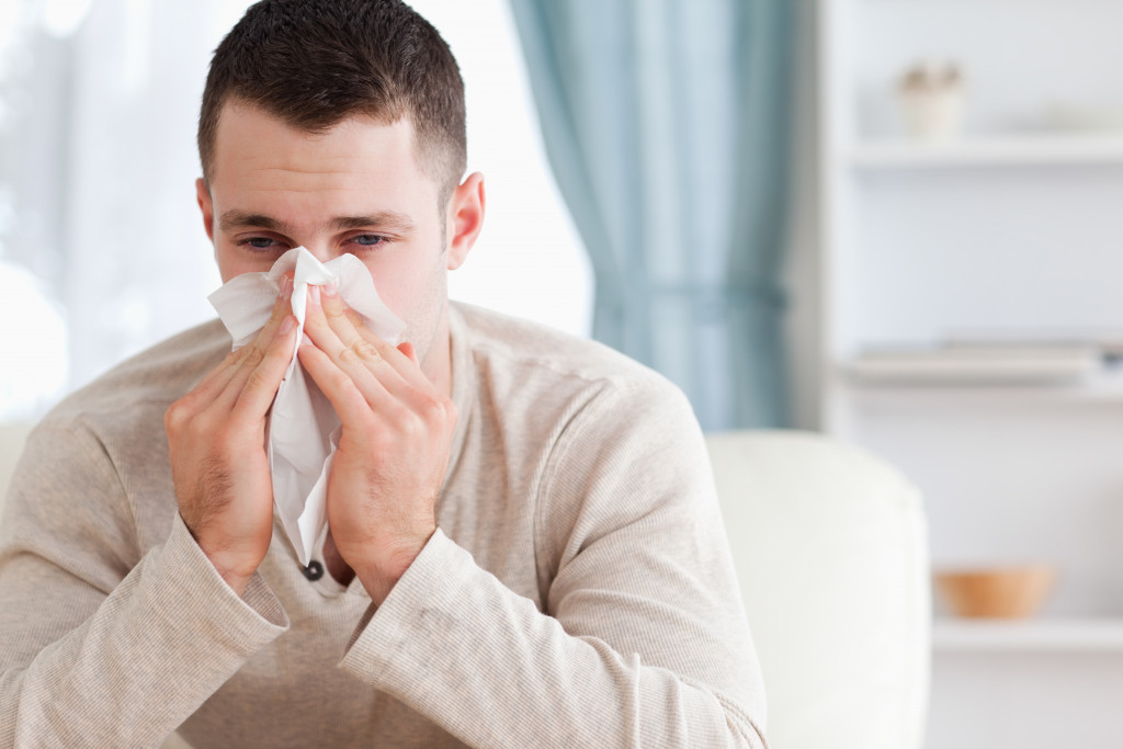 A man sneezing due to colds