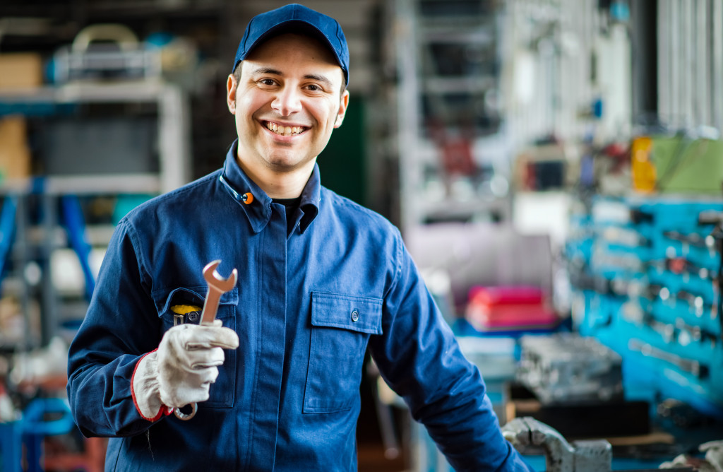 A mechanic smiling to the camera